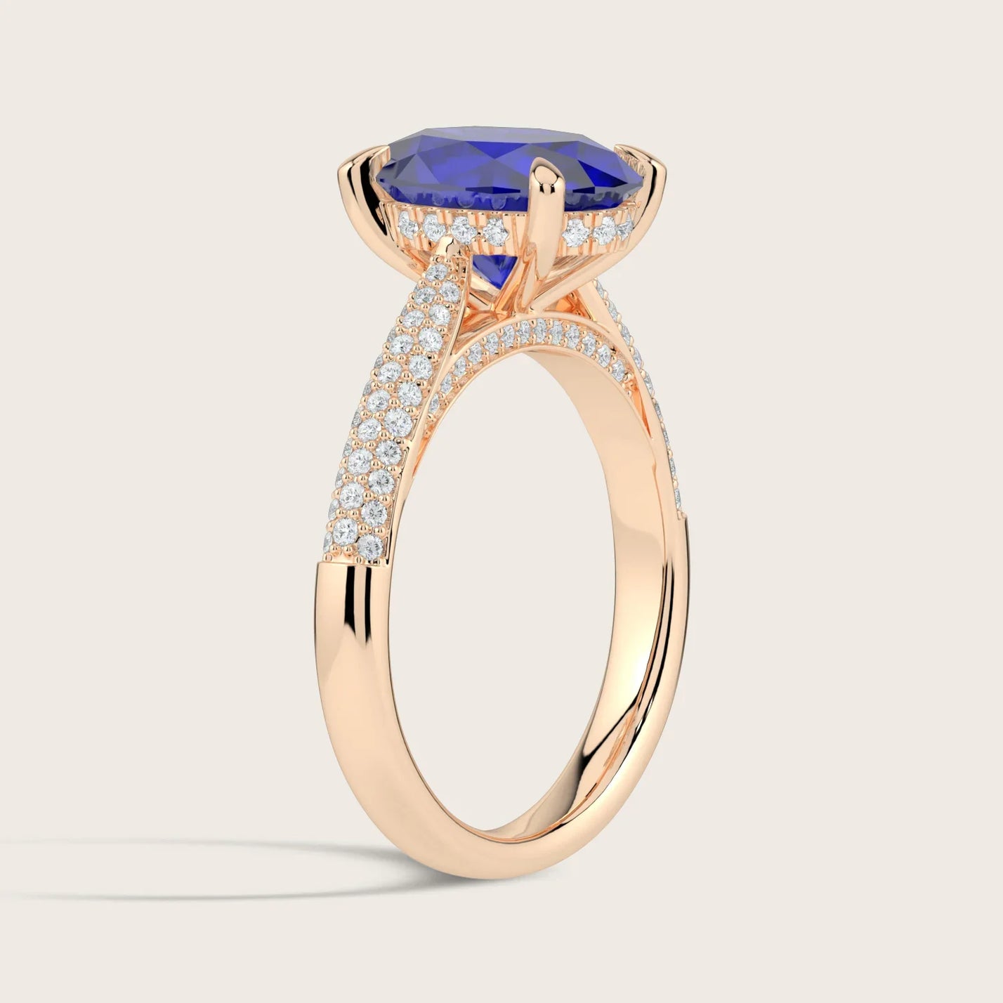 Rose gold ring with oval sapphire, "hidden halo" diamonds, and diamond band.