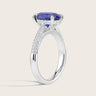 Lab-grown oval sapphire ring. "Hidden halo" diamond band in 18k white gold. Side view.