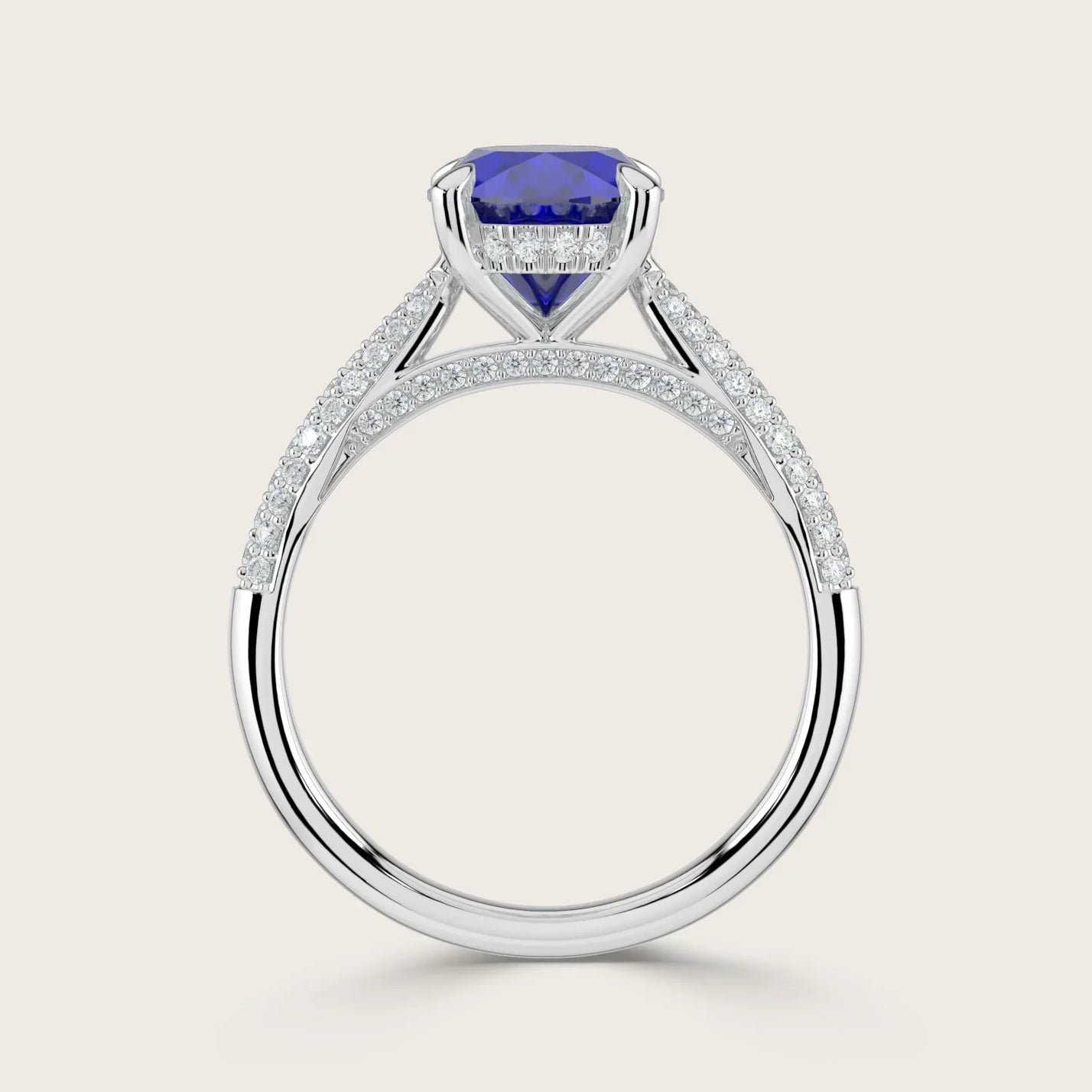 Lab-grown oval sapphire ring with a "hidden halo" and diamond band in 18k white gold.