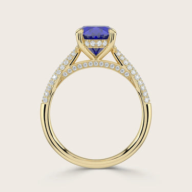 18k gold ring with oval lab-grown sapphire, "hidden halo" diamonds, and diamond band detail.