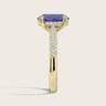 Lab-grown oval sapphire ring in 18k yellow gold with a "hidden halo" and diamond band detail.