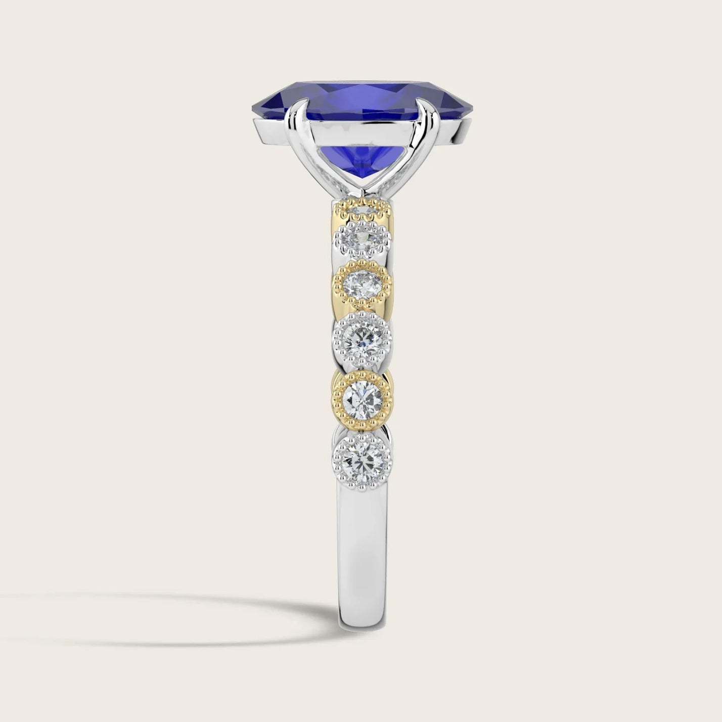 Side view of "R24822OVA" ring: Oval lab-grown sapphire, diamond milgrain band, two-tone 18k gold. Vintage style.