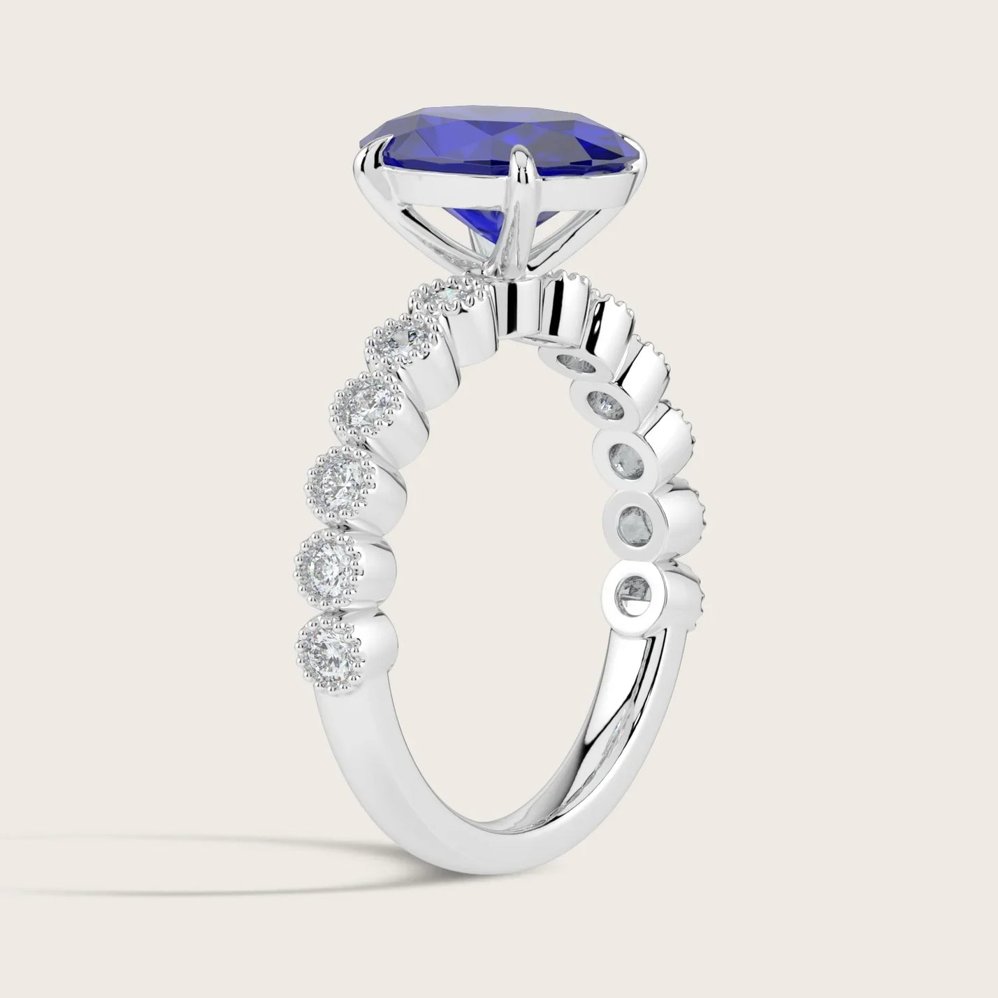 Lab-grown oval sapphire ring in 18k white gold with a milgrain vintage diamond band. Side view.