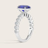 Lab-grown oval sapphire ring in 18k white gold with a milgrain vintage diamond band. Side view.
