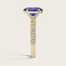 Side view of "R24822OVA" ring: Oval lab-grown sapphire in 18k yellow gold, milgrain vintage diamond band detail.