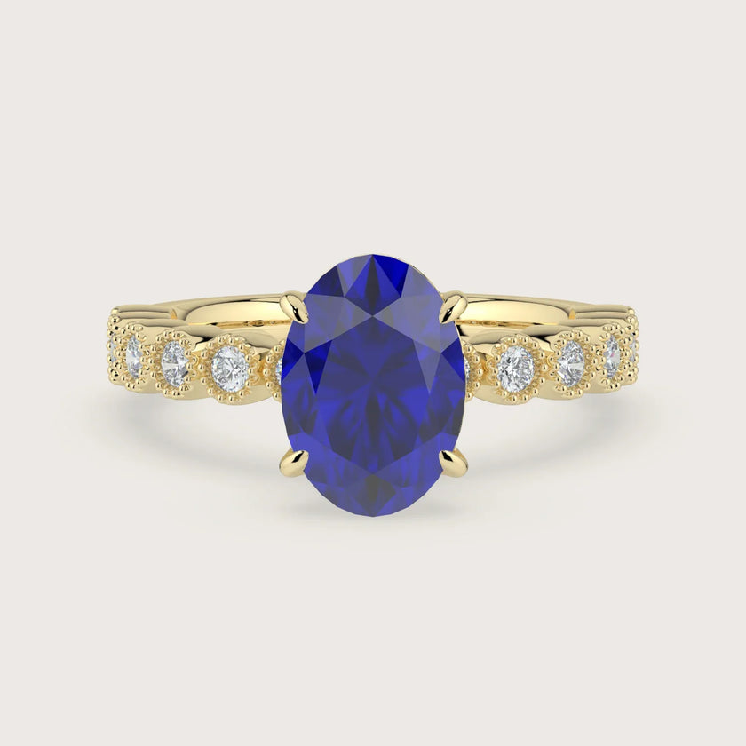 Oval lab-grown sapphire engagement ring. 18k yellow gold, vintage milgrain diamond band detail. "R24822OVA.