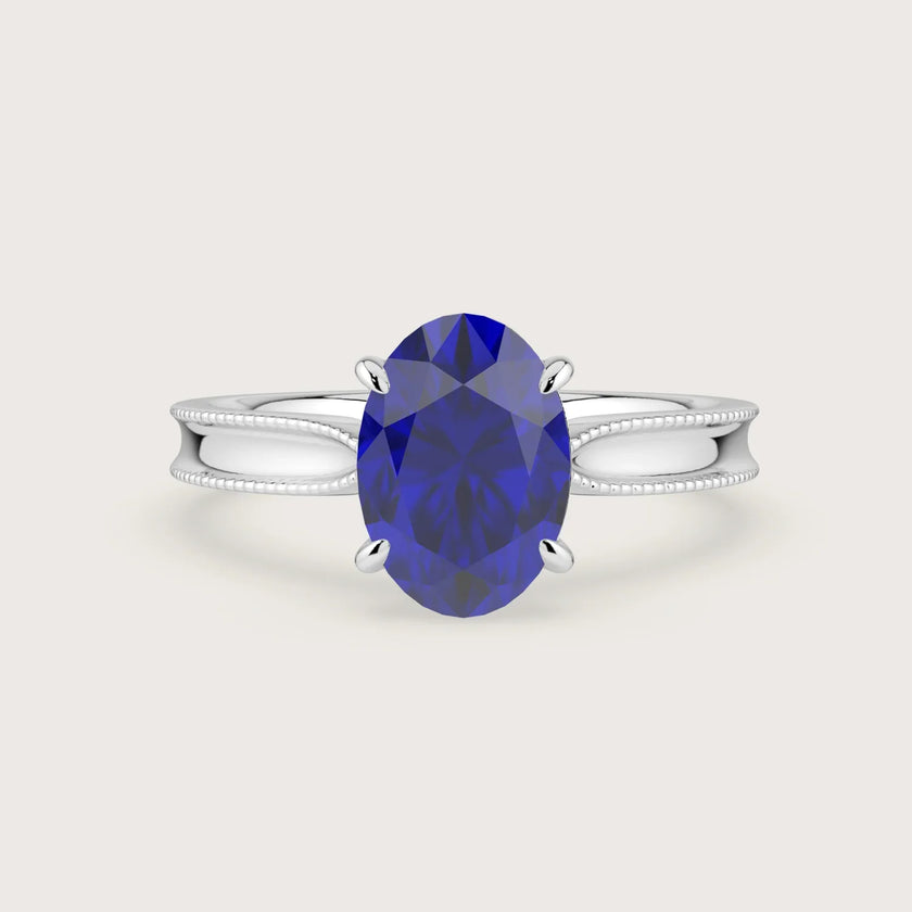 Oval lab-grown sapphire solitaire engagement ring in 18k white gold with milgrain detailing. "R24821OV.