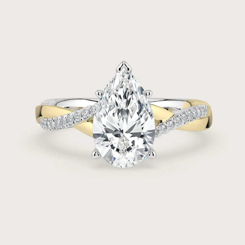 Lab-grown pear diamond engagement ring. 18k two-tone gold twist band with diamonds. "R24823PEA" detail.
