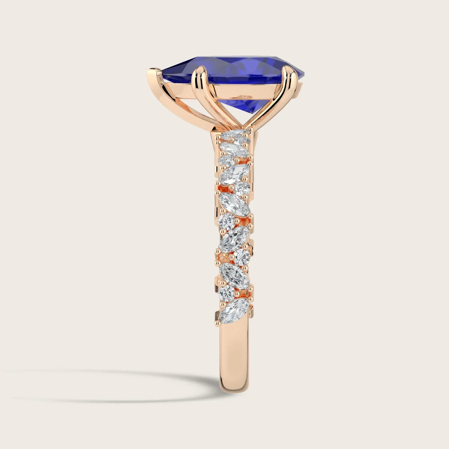 Side view of "pear sapphire" ring. Lab-grown gem, diamond band, 18k rose gold.
