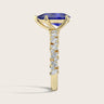 Lab-grown "pear" sapphire ring. 18k yellow gold band with diamond accents, side view.
