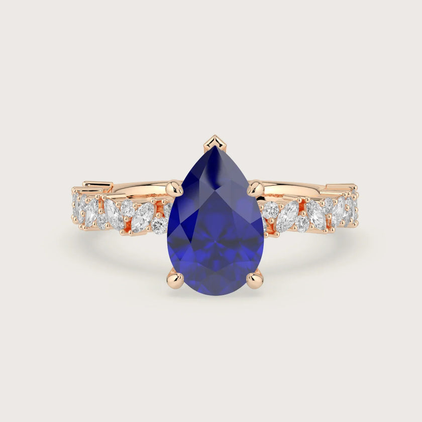 Rose gold engagement ring with pear-shaped lab-grown sapphire and diamond band. "R24830PEA.