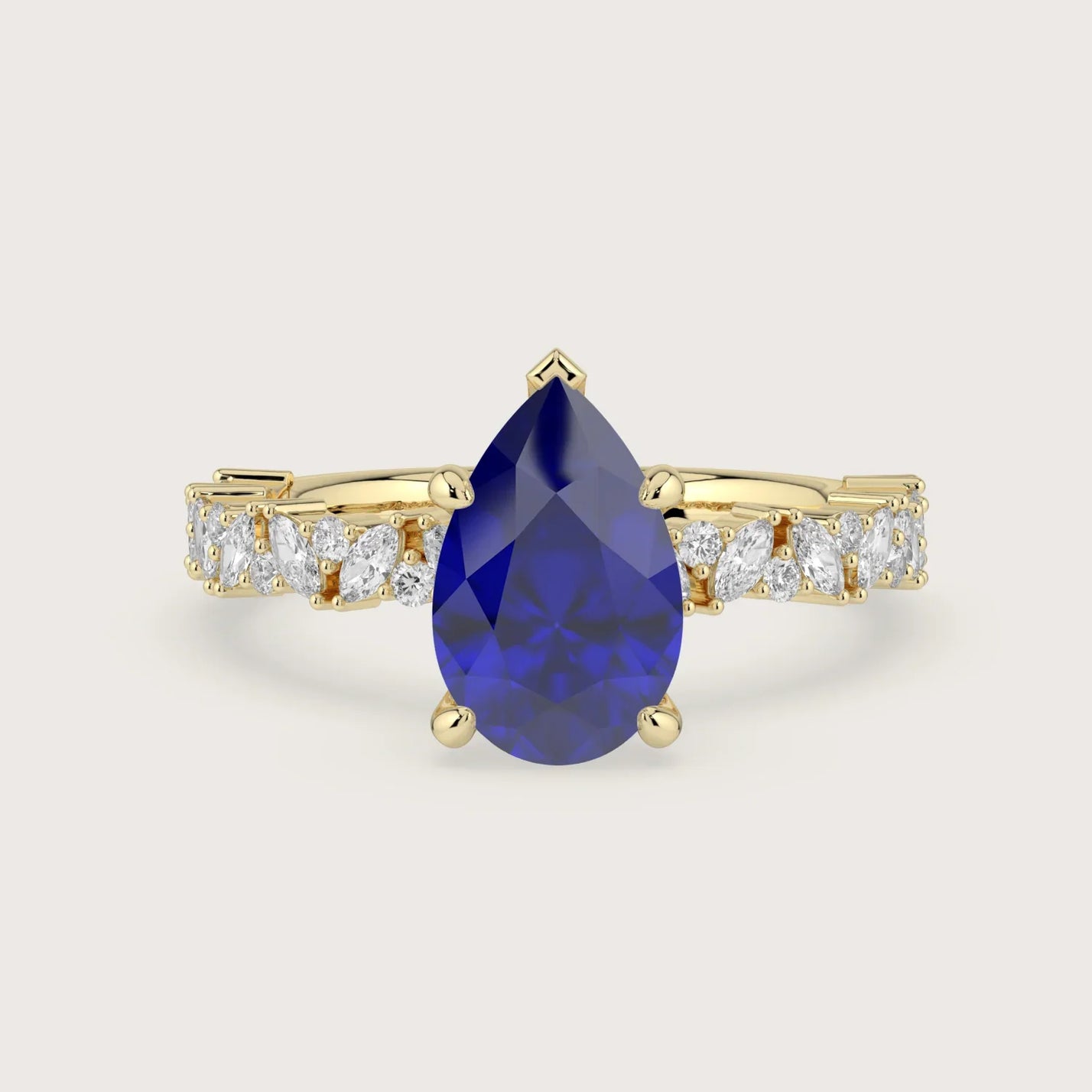 18k yellow gold engagement ring featuring a pear-shaped "lab-grown sapphire" and diamond band.