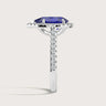 Pear-shaped lab-grown sapphire ring in 18k white gold, with diamond halo and band. Side view.