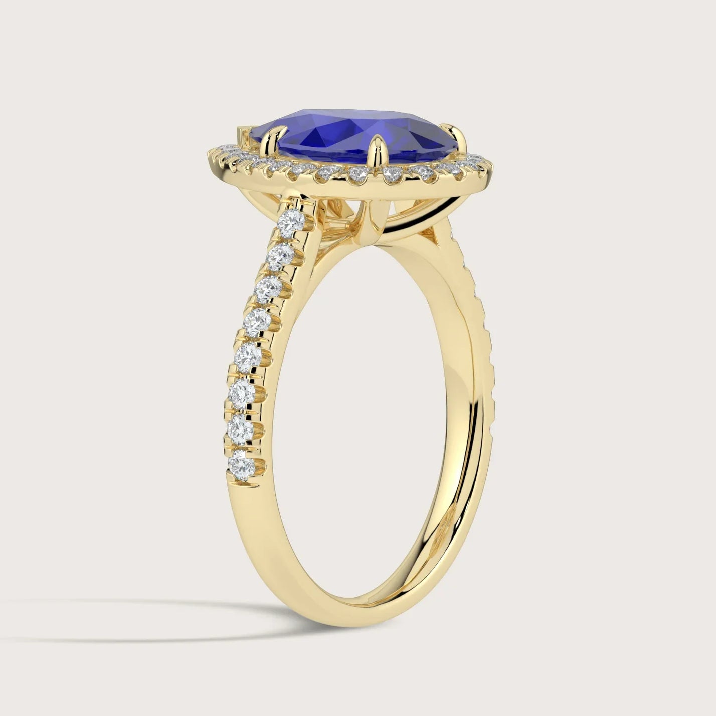 Gold ring with pear-shaped lab-grown sapphire, diamond halo and band detail. "R24818PEHA.