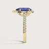 Lab-grown pear sapphire ring in "18kyg" with diamond halo and band, side view.