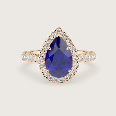 Pear-shaped lab-grown sapphire engagement ring with diamond halo and band in 18k rose gold.