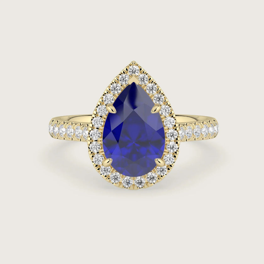 Lab-grown" pear sapphire engagement ring with diamond halo and band, 18k yellow gold.