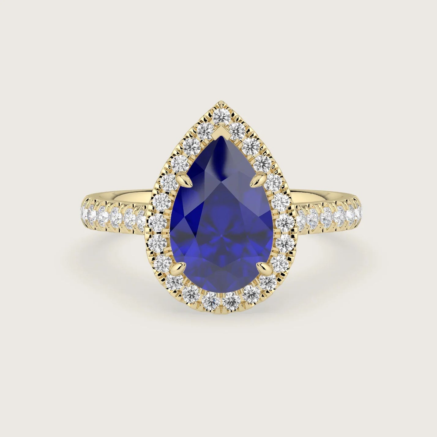 Lab-grown" pear sapphire engagement ring with diamond halo and band, 18k yellow gold.