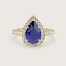 Lab-grown" pear sapphire engagement ring with diamond halo and band, 18k yellow gold.