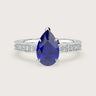 Pear-shaped lab-grown sapphire engagement ring with milgrain diamond band in 18k white gold.