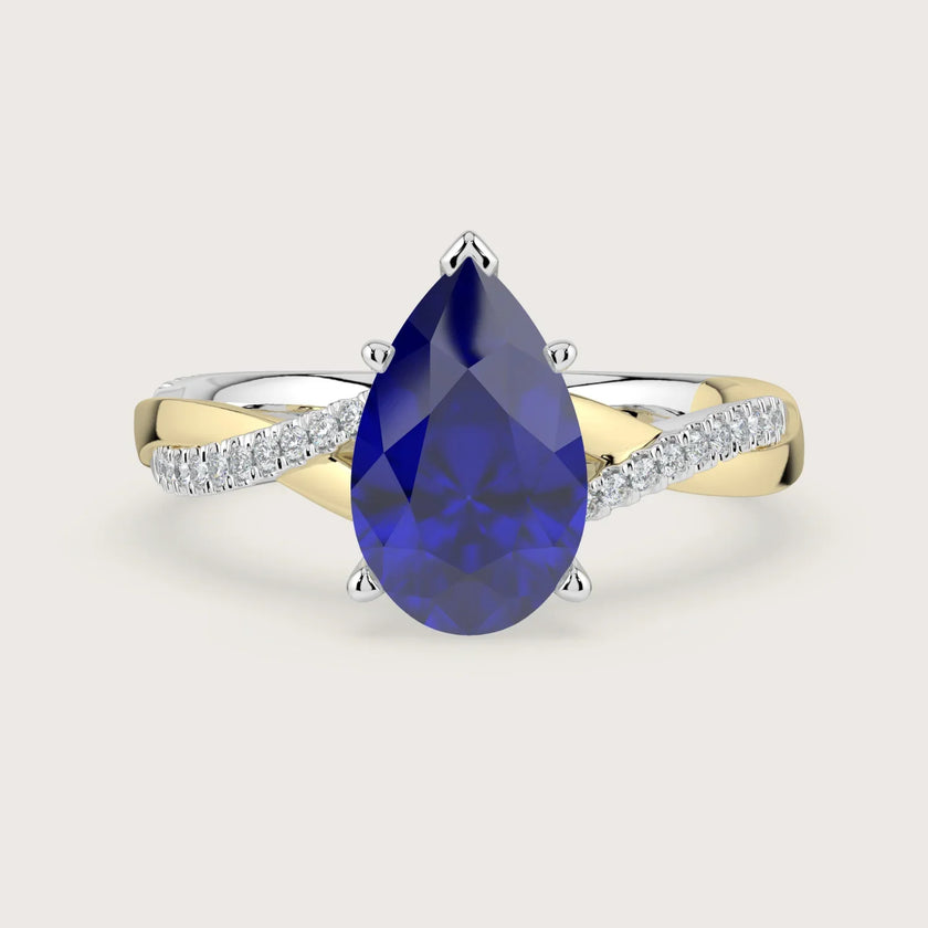 Pear sapphire engagement ring. Two-tone 18k gold twist band with diamonds. "R24823PEA" visible.