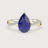 Pear sapphire engagement ring. Two-tone 18k gold twist band with diamonds. "R24823PEA" visible.