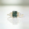 Lab-grown radiant green diamond ring. 18k yellow gold "The Chapters" design with side stones.